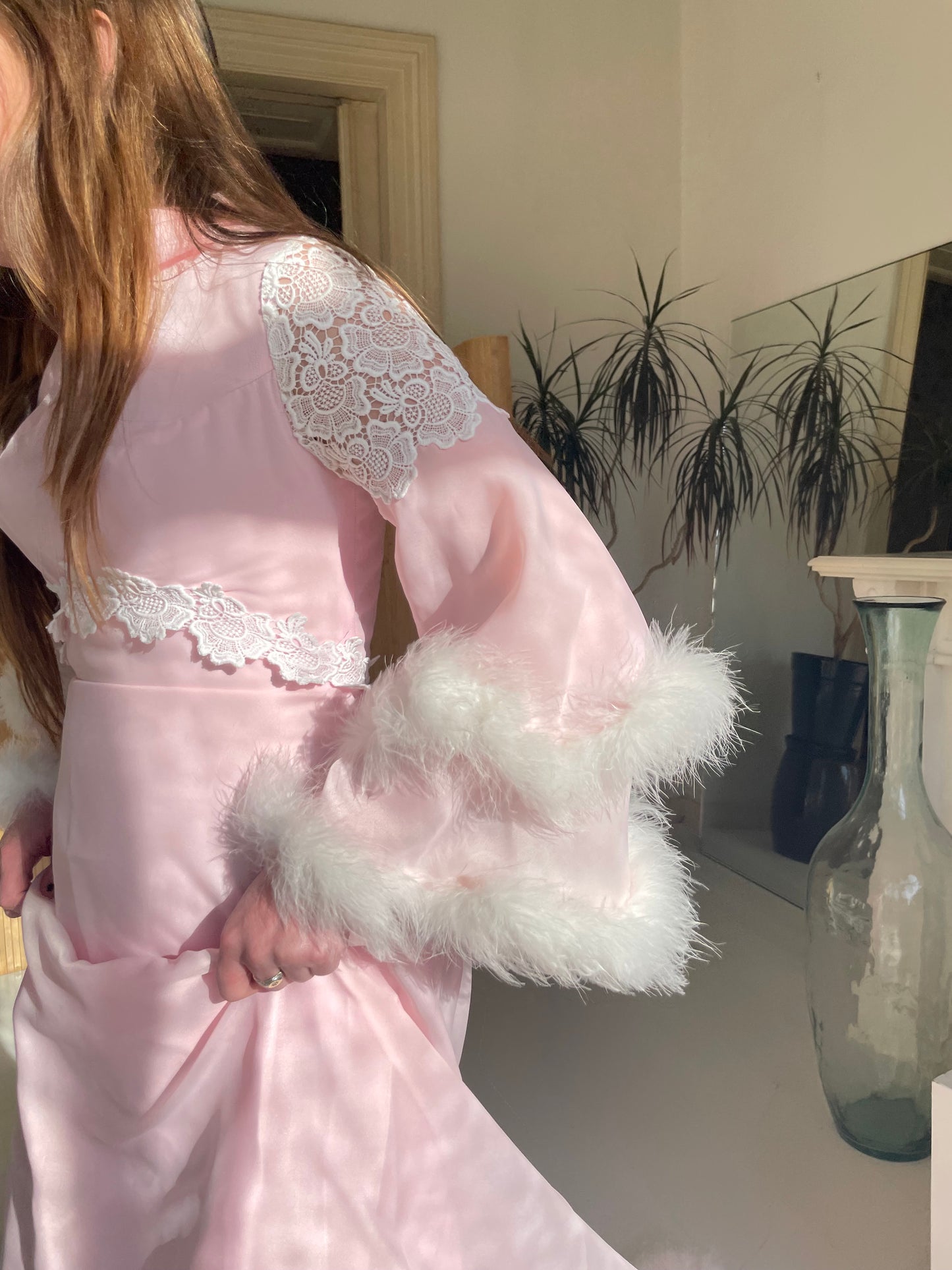 Pink feather trimmed gown with train