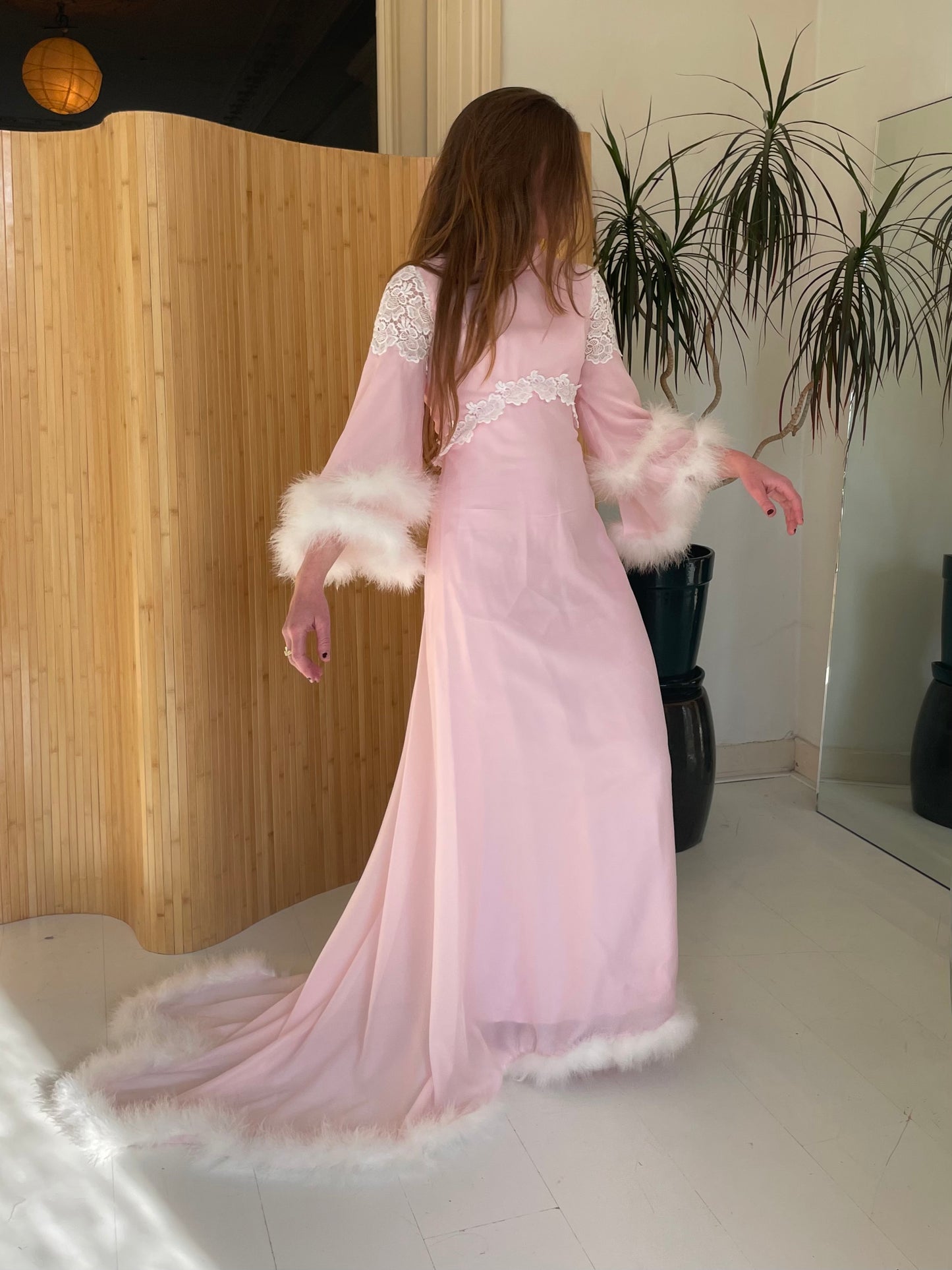 Pink feather trimmed gown with train