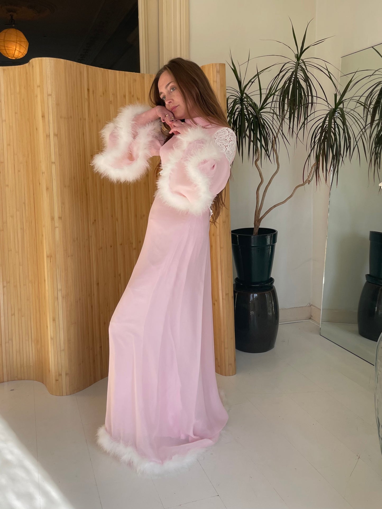Pink feather trimmed gown with train